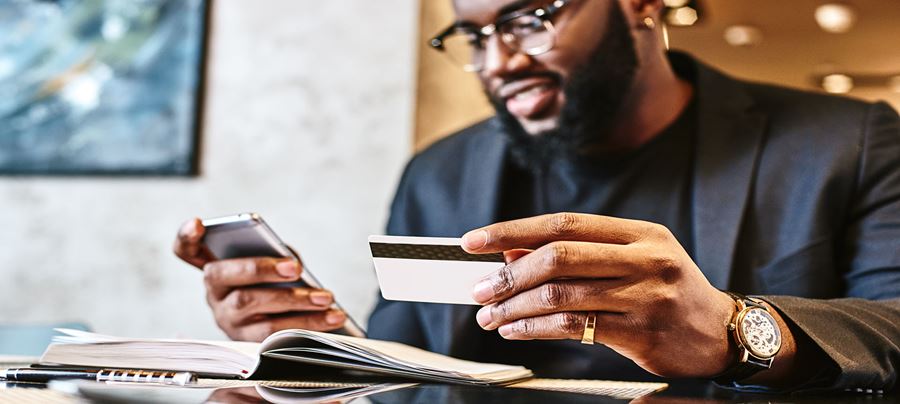 Man inputting credit card information on a cell phone